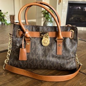 Used leather Michael Kors signature purse w/shoulder strap. Great condition.